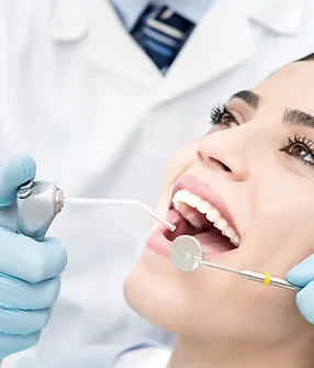 Patient receiving a dental exam for the new-patient exam, X-ray, and cleaning offer