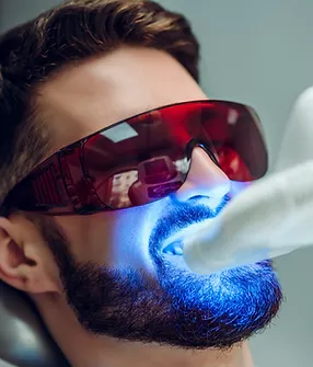Patient receiving professional teeth whitening treatment